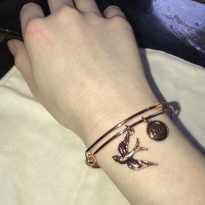 Adjustable rose gold colored charm bracelet.